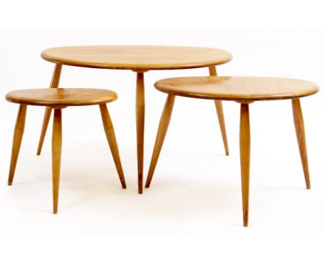 AN ERCOL LIGHT ELM NEST OF THREE TABLES  with spindle supports, the largest 65cm wide x 44cm deep x 39cm high