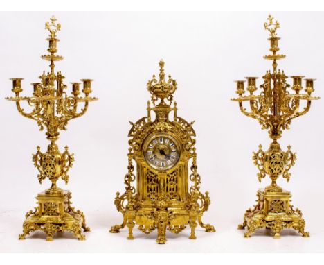 A FRENCH BRASS GARNITURE CLOCK the movement by Barrard &amp; Vignon, all with scrolling pierced decoration and having two fiv