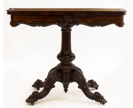 AN EARLY VICTORIAN ROSEWOOD FOLD OVER CARD TABLE with carved scrolling decoration, 91cm wide x 45.5cm deep x 74cm high