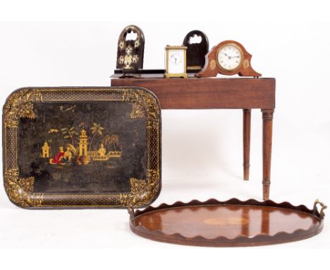 AN EDWARDIAN MAHOGANY OVAL TRAYwith twin brass handles, a Toleware tray with gilded decoration, a coromandel book stand, a br