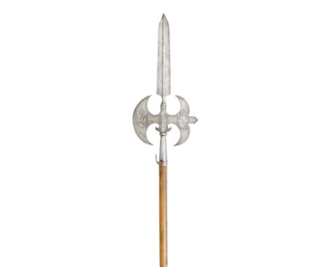 with tapering double-edged terminal blade formed with a medial ridge, border-engraved curved axe-blade and 'm' shaped rear fl