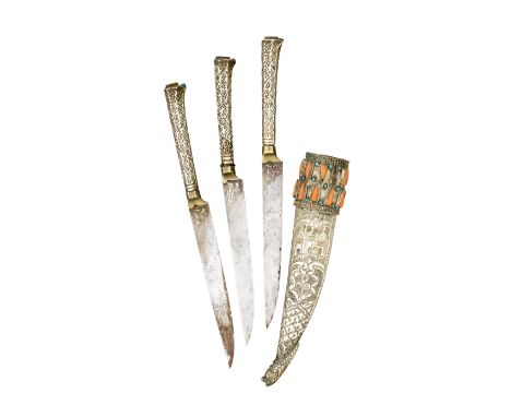 formed of three single-edged knives, each decorated with gold scrollwork at the forte, and chased silver grip, in a silver-co