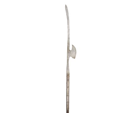 with slightly curved terminal sword blade swelling to a double-edged point and cut with a long slender fuller along the back-