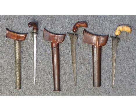 the first with tapering double-edged pattern-welded blade (mendak and selut missing) and carved Sulawesi jawa demam hilt, in 