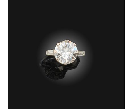A diamond ring, set with a circular-cut diamond weighing approximately 4.95cts, the shoulders set with baguette diamonds, siz