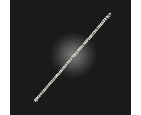 An Art Deco diamond line bracelet, 1920s, designed as an articulated line of graduated square and rectangular step-cut diamon