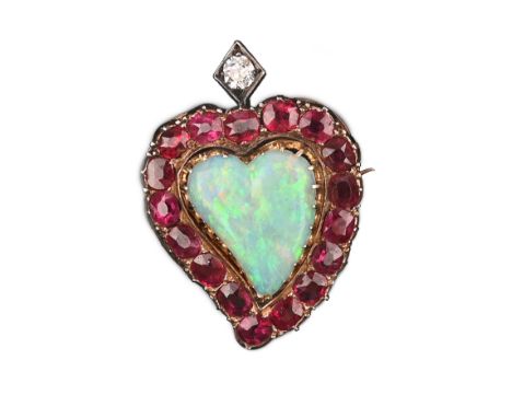 A late Victorian gem-set witches heart brooch, the solid white opal heart set within a surround of rubies and a diamond accen