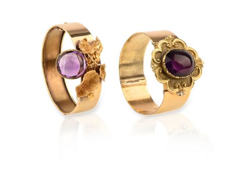 Two Victorian amethyst bangles, one gold bangle of hinged design, applied with a naturalistic spray of gold leafs set with a 