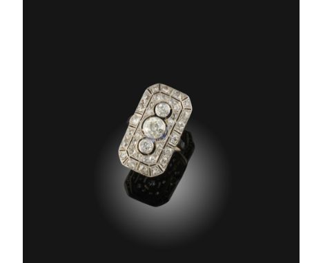 A diamond set white gold ring, circa 1920, designed as an open work plaque with millegrain borders, set with circular-cut dia