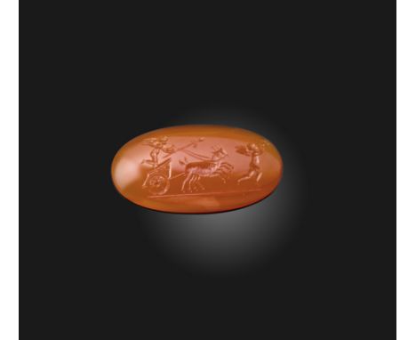 A carnelian intaglio, early 19th century, of oval outline, engraved with a procession of putti, one putto playing pipes, the 