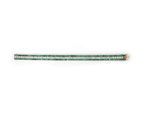 An emerald and diamond strap bracelet, 1920s, designed as a line of circular-cut diamonds within borders of step-cut emeralds