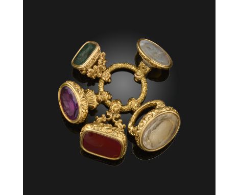 An early 19th Century gold split ring, with five early 19th Century fob seals, mounted with a citrine carved with the profile