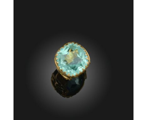 A paste stone ring, France, circa 1900, set with a large cushion-shaped greenish blue paste stone, to a gold mount with openw