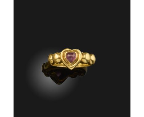 A pink tourmaline ring by David Morris, the cabochon heart-shaped tourmaline set within polished 18ct yellow gold surround an