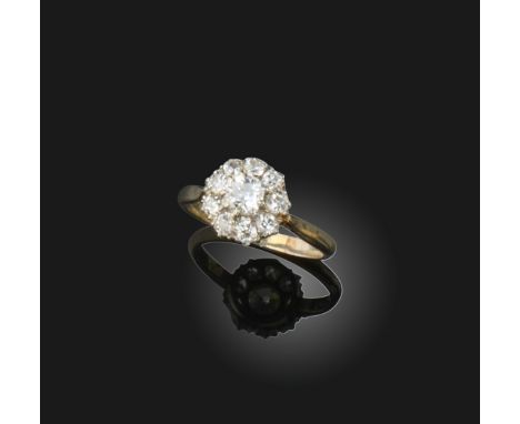 A diamond cluster ring, the old cushion-shaped diamond is set within a surround of smaller old circular-cut diamonds in white