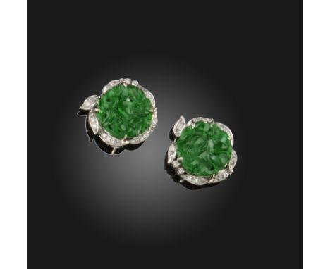 A pair of jade and diamond earrings, the carved jadeite discs set within a border of diamonds in white gold, 1.8cm wide, earr