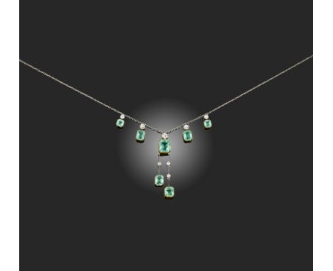 An Edwardian emerald and diamond negligée necklace, circa 1910, the fine link chain suspending four step-cut emeralds from ci
