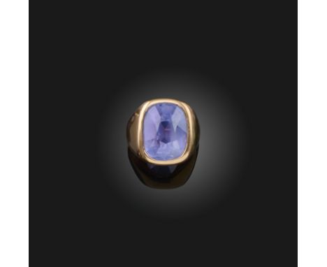 A sapphire solitaire ring, the cushion-shaped sapphire weighing over 20.00cts, collet-set in a brushed gold setting, size P