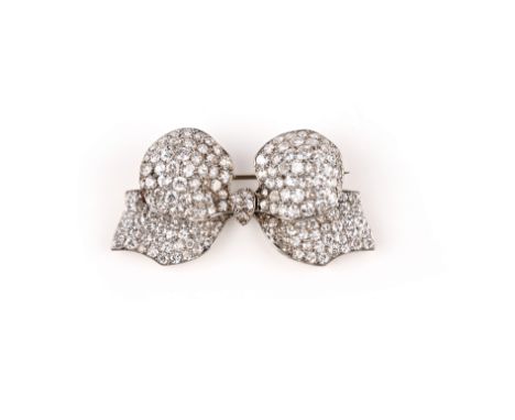 A diamond brooch, France, circa 1920, designed as a ribbon tied in a bow, pavé-set with circular-cut diamonds, French assay m