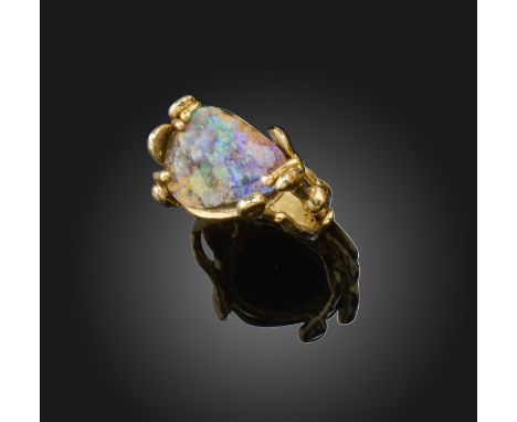 A boulder opal-set gold ring, in the style of Arthur King, the solid boulder opal set in textured abstract gold shank, size R