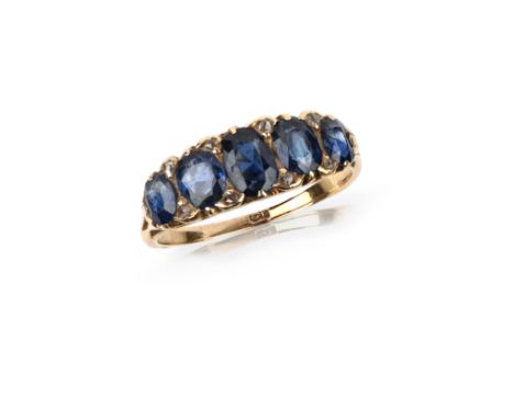 A sapphire and diamond half hoop ring, set with five graduated cushion-shaped sapphires with diamond pointers in carved and p