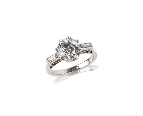 A diamond solitaire ring, set with a central circular-cut diamond weighing approximately 2.05 carats, with baguette-shaped sh