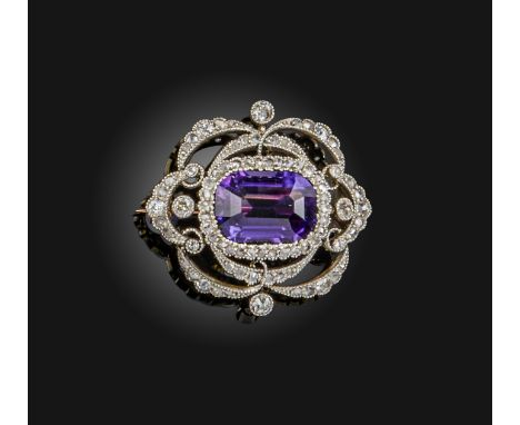 An Edwardian amethyst and diamond set silver and gold brooch, circa 1900, set with a step-cut amethyst, within an open work s