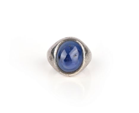 A sapphire ring, set with a polished sapphire, to a tapered silver mount, size D1/2 