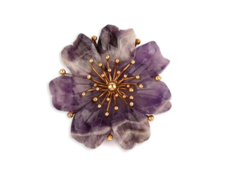 An amethyst and gold brooch, circa 1975, designed as a flower in carved amethyst, mounted in 18ct gold, British hallmarks, sp