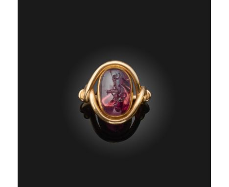 A carved spinel ring, collet-set with a spinel cabochon with a concave back, carved with an Arabic inscription, to a mount of