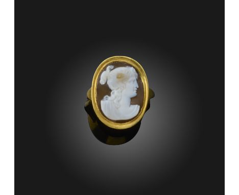 An onyx cameo ring, 19th century, the oval grey, brown and white onyx carved with a bust of Psyche in profile, a butterfly wi