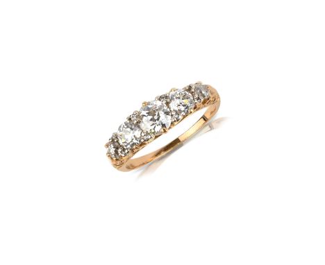 A late Victorian diamond five stone ring, set with graduated old circular-cut diamonds and diamond pointers in carved and pie