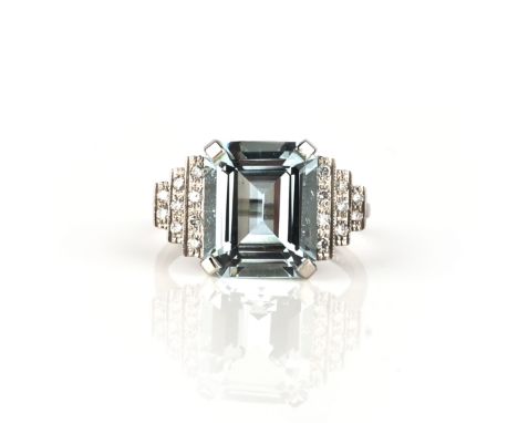 An aquamarine and diamond ring, claw-set with a step-cut aquamarine weighing approximately 5.00 carats, to stepped shoulders 