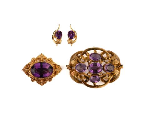 Two amethyst brooches, mid 19th century, and a later pair of amethyst earrings, the brooches each set with oval amethysts wit