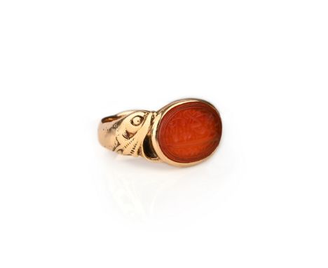 A mid 19th century carnelian intaglio ring, inscribed with Arabic script for the prophet Ali, on a stylised gold band where t