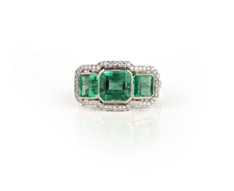 An emerald and diamond ring, set with three step-cut emeralds weighing 0.90, 2.36 and 0.91 carats respectively, within an ope