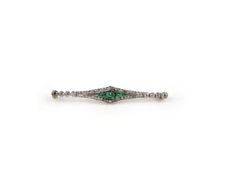 An Edwardian emerald and diamond brooch, set with a central lozenge of tapering emeralds within a surround of single-cut diam