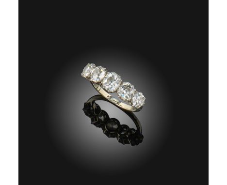 A five-stone diamond ring, early 20th century, set with a sequence of five graduated cushion-shaped diamonds in claw settings