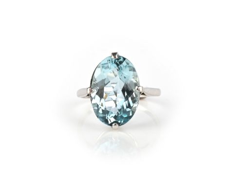 An aquamarine ring, claw-set with an oval aquamarine weighing approximately 7.00 carats, to a plain white gold mount, size R1