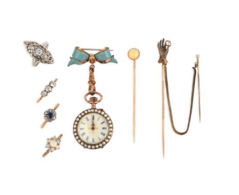 A group of jewellery, comprising: three stick pins, one set with a cabochon opal, one designed as a hand with shirt cuff hold