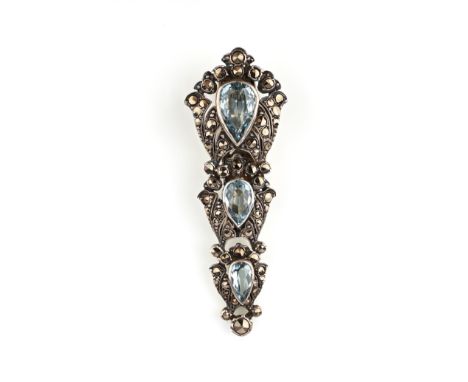 An aquamarine and marcasite clip brooch, Sybil Dunlop, composed of three graduated pear-shaped aquamarines in scrolled frames