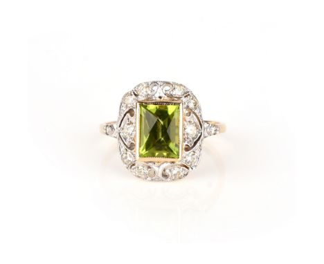 A peridot and diamond ring, centring on a square mixed-cut peridot, within an openwork mount millegrain-set with brilliant-cu