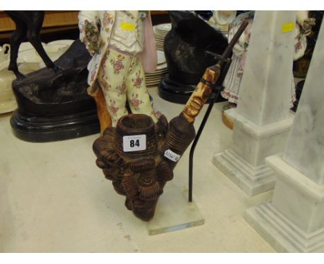 A tribal ceremonial pipe, terracotta and bone on stand, signed