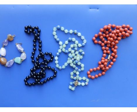 A jade coloured bead necklace, two othyers and a stone bracelet. (4)