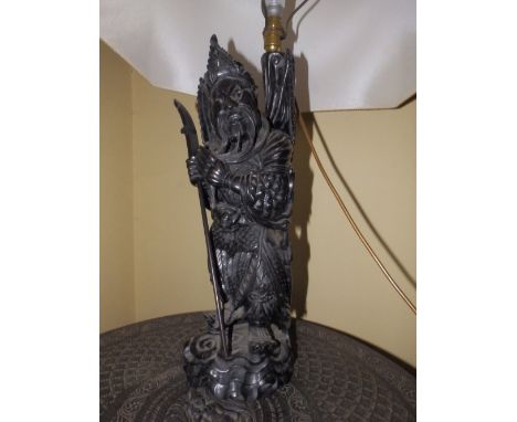 A Chinese carved wood figural table lamp depicting a winged warrior, 20”.