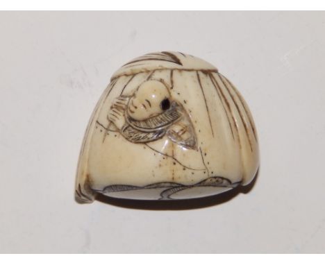 A Japanese bone netsuke depicting a man appearing out from a tent, 1.5”