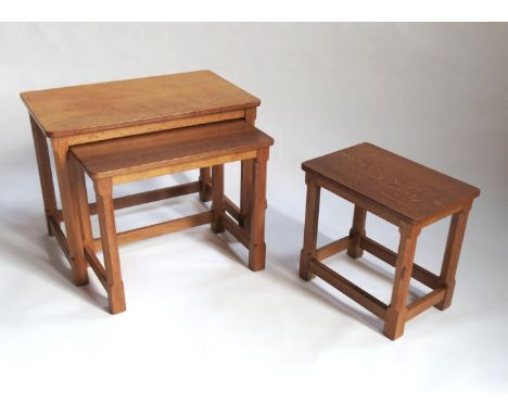 A nest of three rectangular oak tables, by Robert Mouseman Thompson, having octagonal legs united by stretchers, width 24ins 