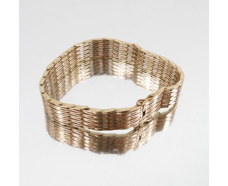 A 9 carat gold bracelet, of gate link like design, to a hidden box clasp with safety catch, 19.5cm long, 28.3g