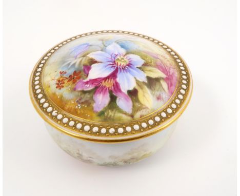 A Royal Worcester circular box and cover, the domed cover decorated with flowers, with jewelled edge, the base decorated with