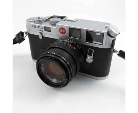 A Leica M6 camera, in chrome, numbered 2175082, with lens